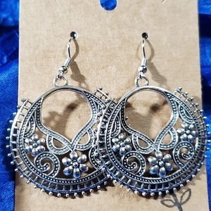 Round earrings detailed with daisies and swirls. Silver and lovely.